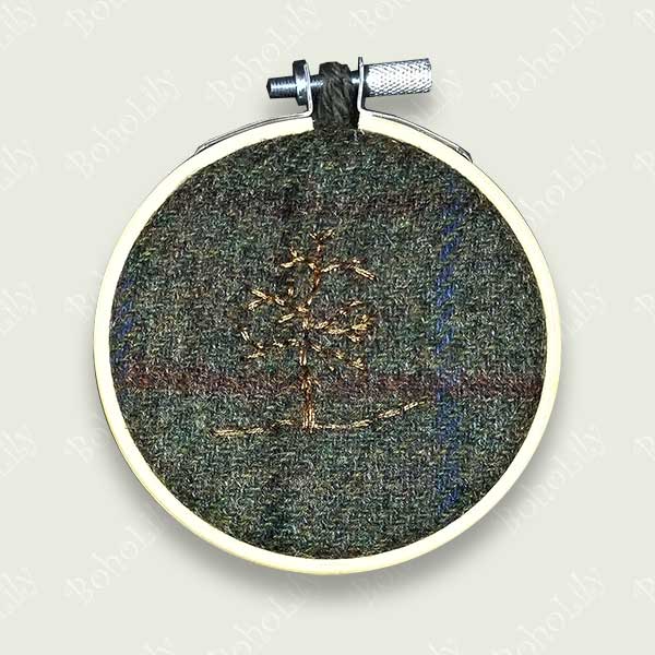 One of the ‘Tweed Collection’  A winter tree embroidered with copper metallic thread stitched on to grey Harris tweed. Supplied with contrasting crocheted  loop made with 100% British Wool. One available.