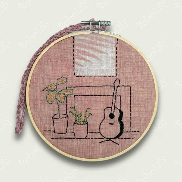 This is a one-off design in my ‘interiors’ collection. Designed  and hand stitched by me using DMC threads onto a subtle pink background with an applique ‘picture’ over the fireplace. The back of the hoop is covered in pale pink wool felt and is ready to hang using the contrasting cotton yarn crocheted  loop. Only one available.
