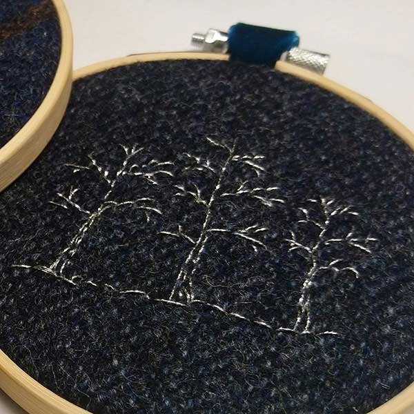 One of the ‘Tweed’ collection. Three silver winter trees stitched onto dark blue Harris tweed fabric.  Supplied with teal velvet ribbon hoop ready for hanging. One available. 