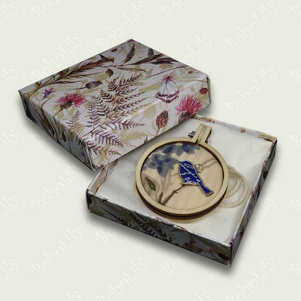 This is a blue bird charm hand stitched with DMC metallic thread on to a recycled fabric background. It comes supplied with a cotton yarn hanging loop and is presented in a pretty handmade gift box making this a delightful one-off gift.  Only one is available.