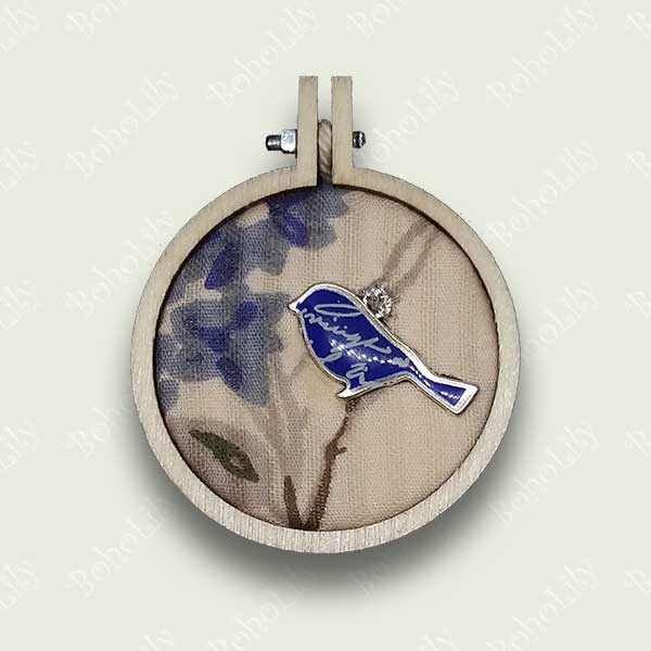 This is a blue bird charm hand stitched with DMC metallic thread on to a recycled fabric background. It comes supplied with a cotton yarn hanging loop and is presented in a pretty handmade gift box making this a delightful one-off gift.  Only one is available.