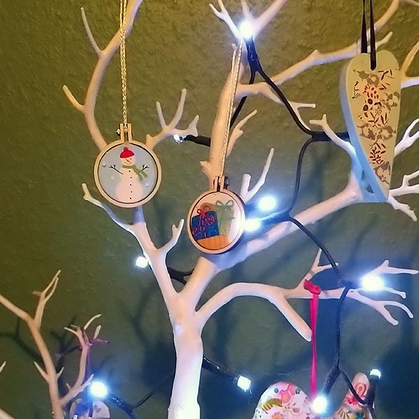 A pair of cute mini hoops in an even cuter hand-made Santa sack.