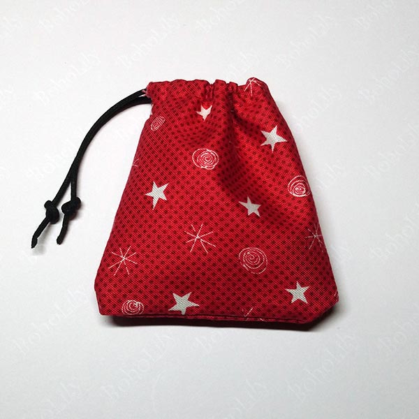 A pair of cute mini hoops in an even cuter hand-made Santa sack.