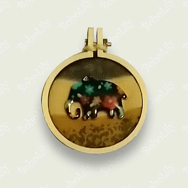 A floral elephant charm stitched onto recycled fabric. 