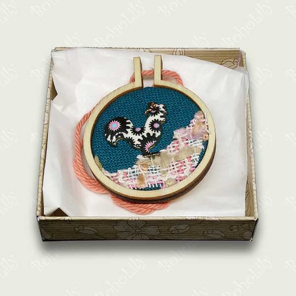 This quirky cockerel charm has been hand stitched using DMC metallic thread onto a dark teal fabric background with a recycled appliqued foreground. It is ready to hang with the contrasting cotton yarn.  This item is supplied in a beautiful handmade gift box making it an ideal and unique present. Only one available