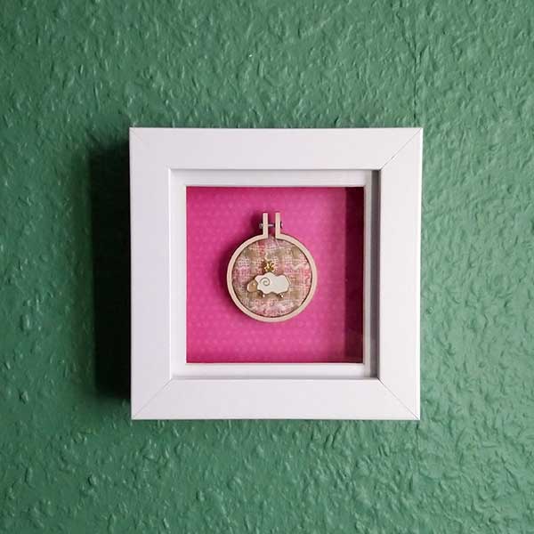 Sheep charm stitched onto recycled fabric using DMC metallic thread in mini embroidery hoop. Mounted onto pink background and framed in a shadow box frame. Freestanding or wall hanging  Only one available.